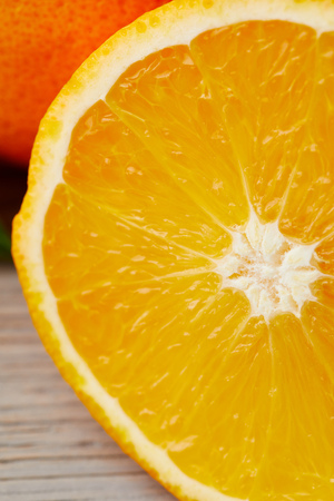 close-up shot of half of orange on wooden surfaceの写真素材