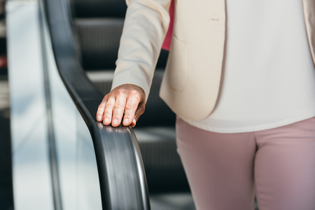 cropped image of woman on escalator in shopping mallの写真素材