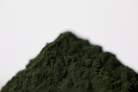 selective focus of spirulina algae powder isolated on grey backgroundの写真素材
