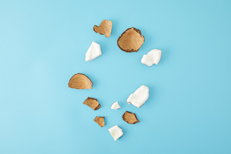 top view of arranged coconut pieces isolated on blueの写真素材