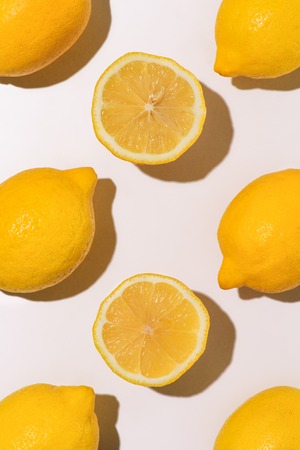 top view of pile of lemons on white surfaceの写真素材