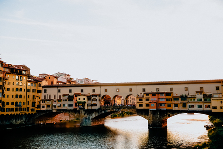 FLORENCE, ITALY - JULY 17, 2017: Famous Ponte Vecchio bridge with river Arno at sunset in Florence, Italyのeditorial素材