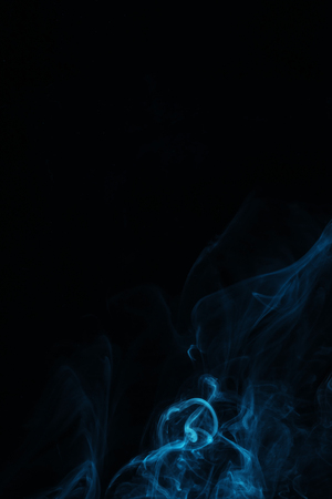 blue swirl of smoke on black background with copy spaceの写真素材