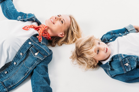 high angle view of mother and son lying on whiteの写真素材