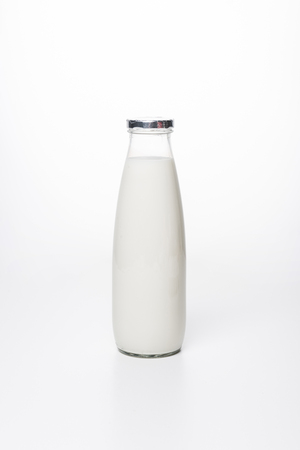 close-up shot of fresh milk in bottle on white surfaceの写真素材