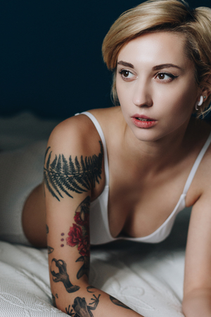 sexy girl in underwear lying on bed and looking awayの写真素材
