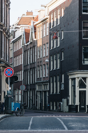scenic shot of street of old buildings at Amsterdam, Netherlandsの写真素材
