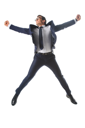 happy businessman in eyeglasses jumping and gesturing by hands isolated on white backgroundの写真素材