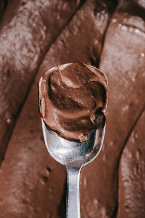 top view of spoon with tasty appetizing brown chocolateの写真素材