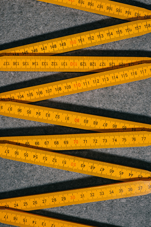elevated view of collapsible meter on grey surfaceの写真素材