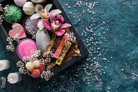 top view of burning candles, handmade soaps and organic spa accessories with flowersの写真素材