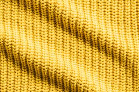 full frame image of wavy yellow woolen fabric background