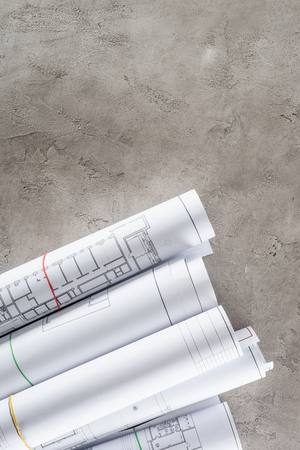top view of arranged architect blueprints on concrete surface