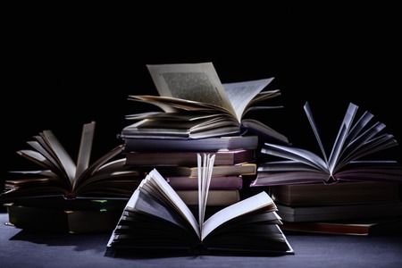stack of books on dark surface on blackの写真素材