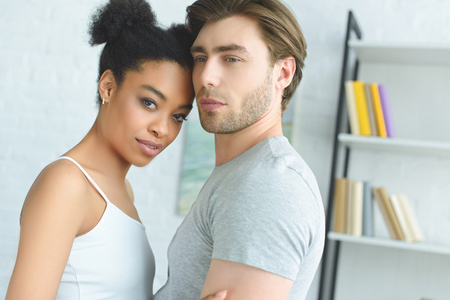 portrait of young multiethnic couple in love at homeの写真素材