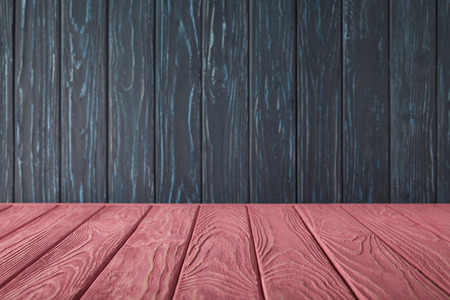 pink striped tabletop and dark blue wooden wallの写真素材