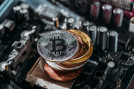 close up view of pile of bitcoins on computer motherboardの写真素材