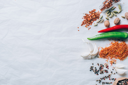 top view of scattered spices on white tableの写真素材