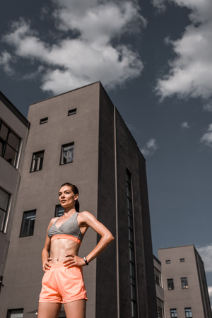 beautiful young sportswoman in sportswear in cityの写真素材