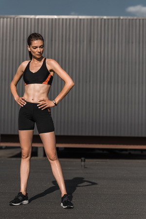 young athletic woman posing with fitness tracker in sportswearの写真素材