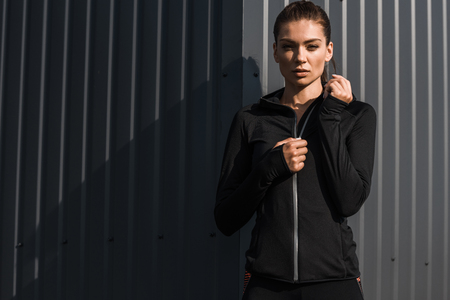 attractive young sportswoman posing in thermal clothes