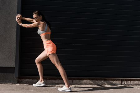 attractive sportswoman training in sportswear in cityの写真素材
