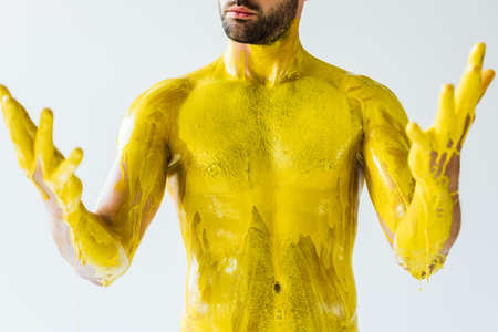 Male body and hands stained with yellow liquid isolated on white backgroundの写真素材