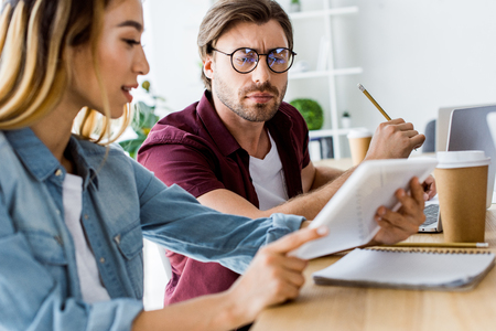 pensive colleagues working on startup project in office and looking at documentsの写真素材