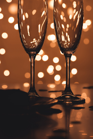 close up view of empty glasses and confetti on tabletopの写真素材