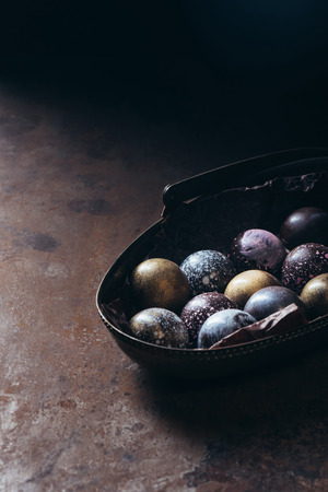 pile of different chocolate candies in metal basket on tableの写真素材