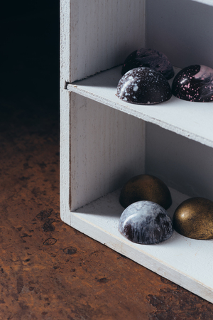 closeup image of different chocolate candies on shelvesの写真素材