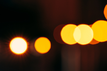close up view of colorful bokeh lights on dark backgroundの写真素材