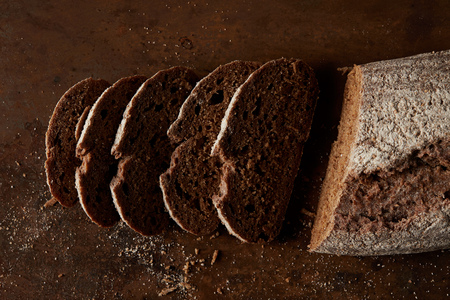 elevated view of bred and slices of bread on rustic metal tabletop