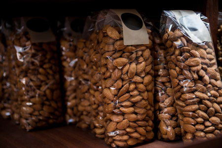 close up view of almonds in plastic packagingの写真素材