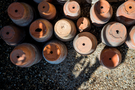 top view of brown handmade ceramic pots on groundの写真素材