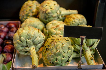 close up view of artichokes and blank chalk boardの写真素材