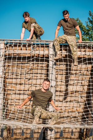 young soldiers practicing during obstacle run on rangeの写真素材