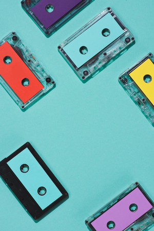 flat lay with arranged colorful retro audio cassettes isolated on blueの写真素材