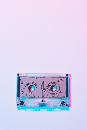 top view of mixtape with good vibes inscription on purple background