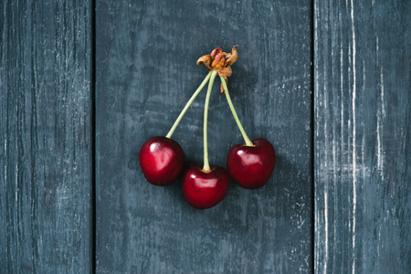 top view of tasty healthy red cherries on rustic wooden surfaceの写真素材