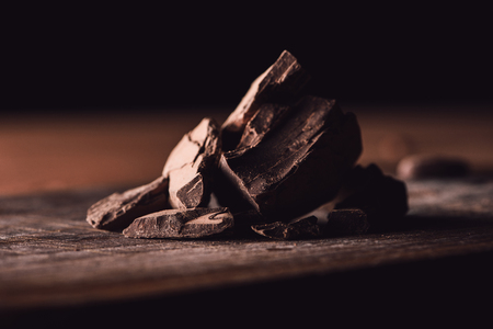 closeup shot of pieces of dark chocolate on wooden tabletopの写真素材