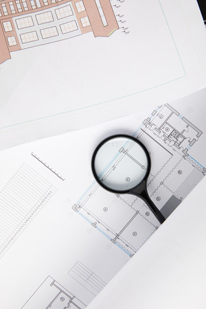 top view of magnifying glass and blueprints, architecture conceptの写真素材