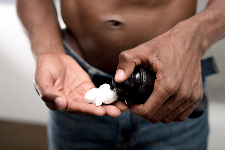 cropped shot of african american man holding shaving foamの写真素材