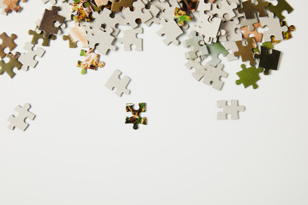 top view of jigsaw puzzle pieces on grey