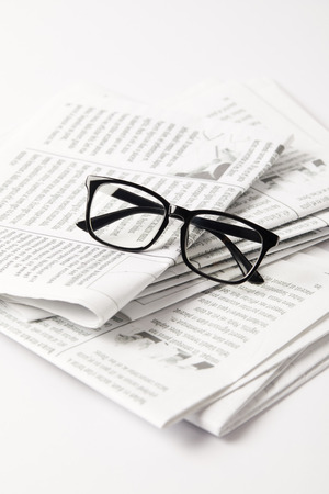 close up of pile of newspapers and eyesight, on whiteの写真素材