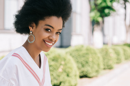 portrait of attractive african american businesswoman looking at camera on streetの写真素材