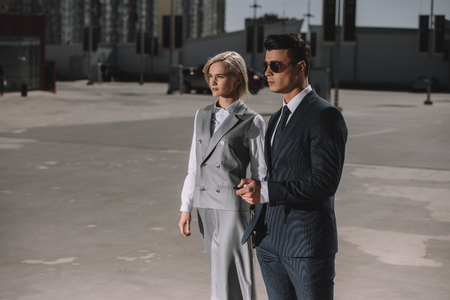 young fashionable business couple walking on parkingの写真素材