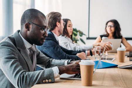 selective focus of multicultural business people having business meeting in officeの写真素材