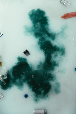 top view of smoke and garbage flowing in water, environment protection conceptの写真素材