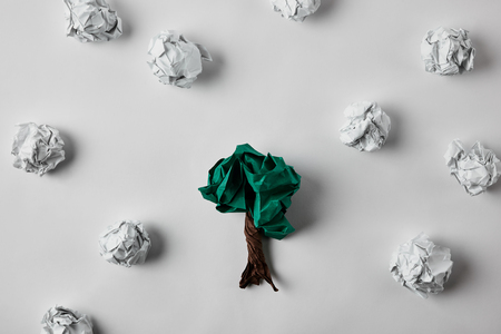 top view of crumpled papers in shape of tree on white surfaceの写真素材